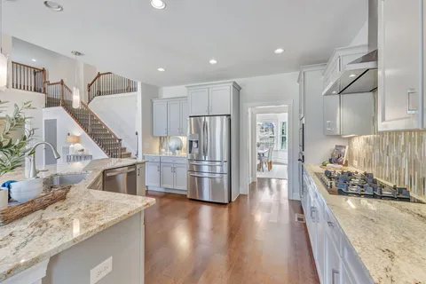 a kitchen with counter top space and wooden floor