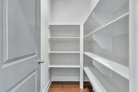 a spacious bedroom with a bed and a table in it