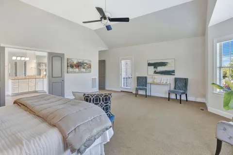 a bathroom with a granite countertop sink toilet a large mirror a vanity and shower