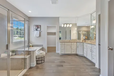 a spacious bathroom with a tub shower and window