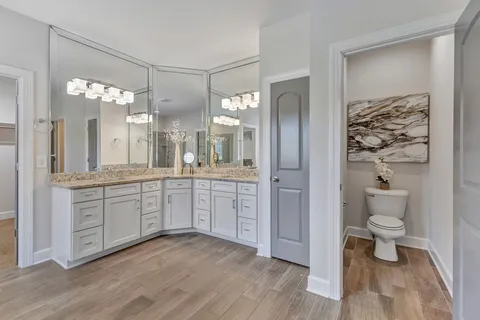 a bathroom with a tub sink toilet and shower