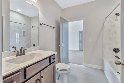 an empty room with windows and chandelier fan