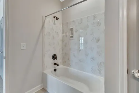 a bathroom with a granite countertop sink a toilet and shower