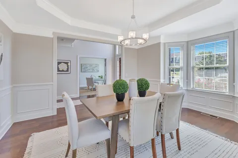 a view of a dining room with furniture and chandelier