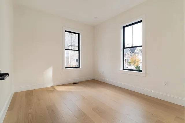 an empty room with windows and closet