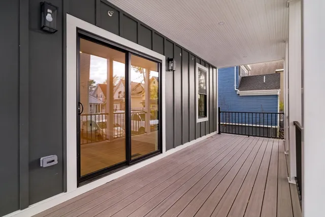 a living room with furniture a flat screen tv and a large window