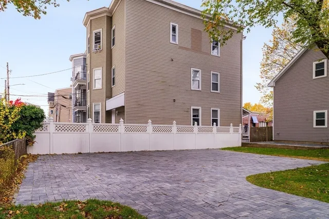 a front view of a residential apartment building with a yard