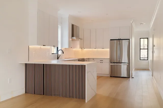 a kitchen with stainless steel appliances a refrigerator and a stove