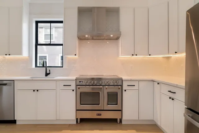 a kitchen with cabinets appliances and a sink