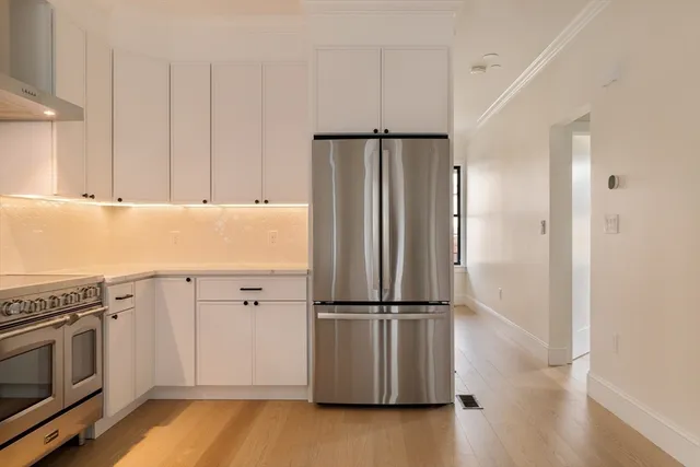 a kitchen with wooden cabinets and stainless steel appliances