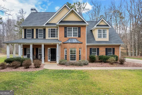 a front view of a house with porch yard and outdoor seating