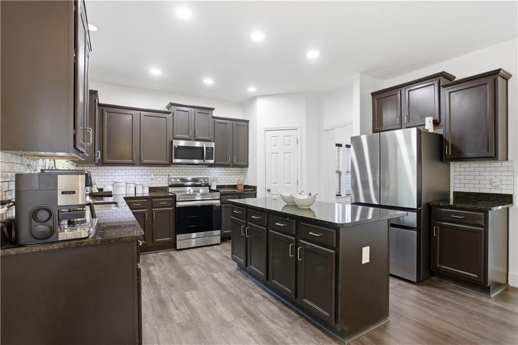 73 Allen Bridge Road Talmo, GA 30575 - Photo 11 of 33 a kitchen with kitchen island granite countertop stainless steel appliances