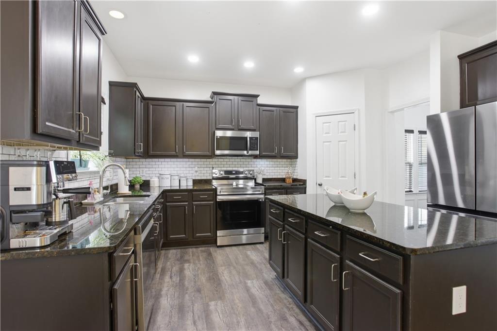 73 Allen Bridge Road Talmo, GA 30575 - Photo 12 of 33 a kitchen with stainless steel appliances granite countertop a sink stove and refrigerator