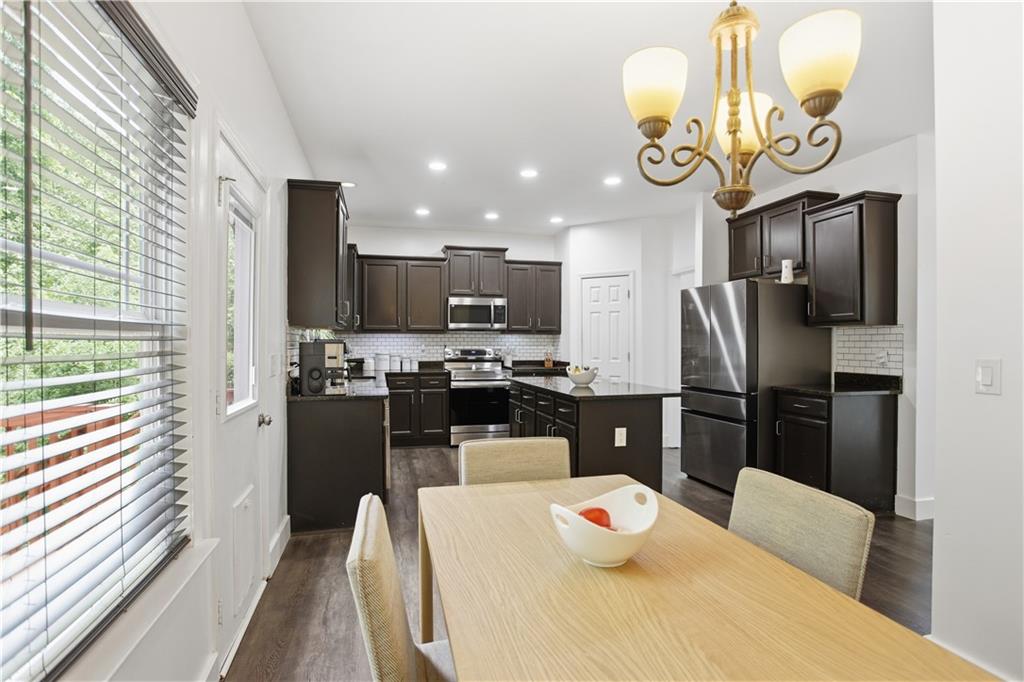 73 Allen Bridge Road Talmo, GA 30575 - Photo 16 of 33 a kitchen with stainless steel appliances granite countertop a refrigerator a microwave oven a sink and dishwasher with a dining table