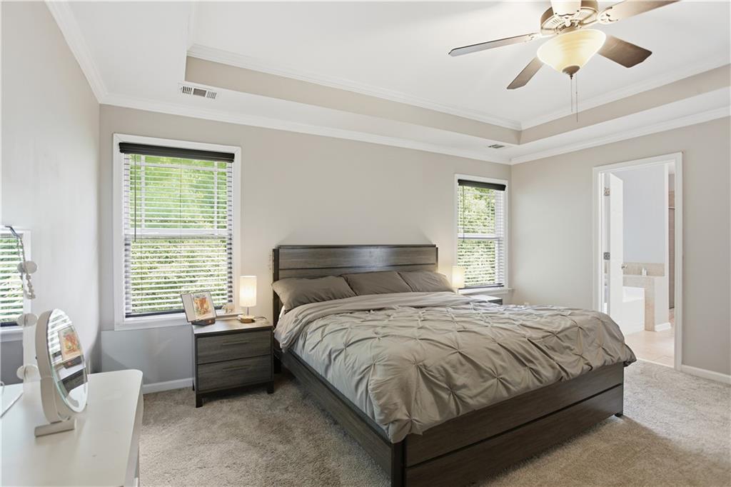 73 Allen Bridge Road Talmo, GA 30575 - Photo 21 of 33 a bedroom with a bed and a chandelier