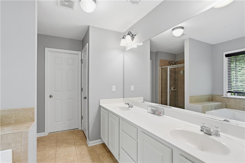 73 Allen Bridge Road Talmo, GA 30575 - Photo 22 of 33 a bathroom with a double vanity sink a mirror and a shower