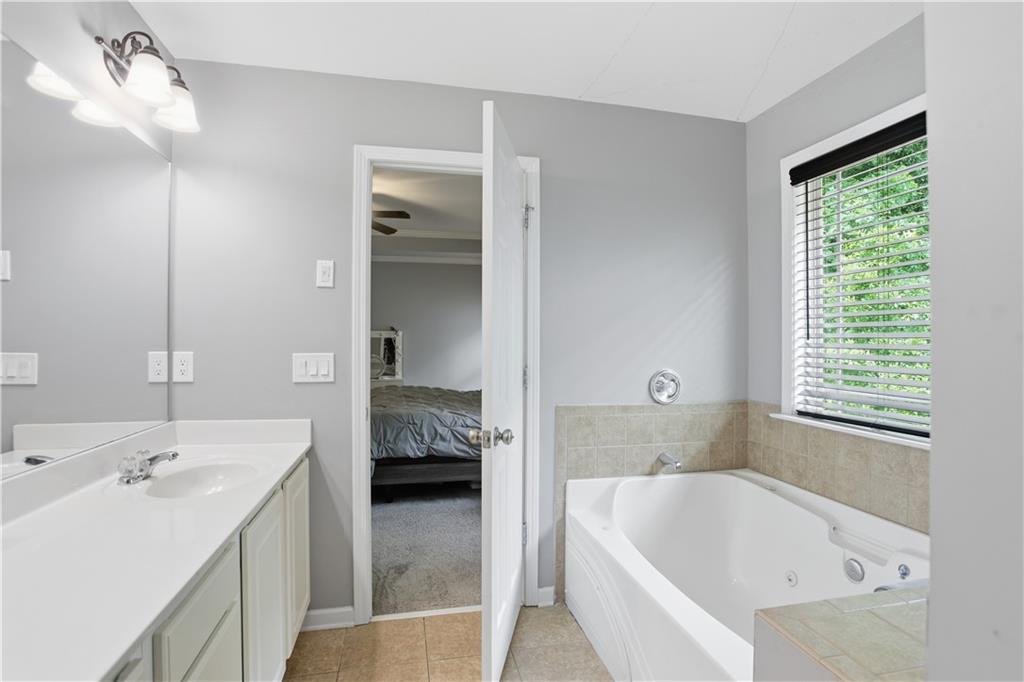 73 Allen Bridge Road Talmo, GA 30575 - Photo 23 of 33 a bathroom with a tub sink and mirror