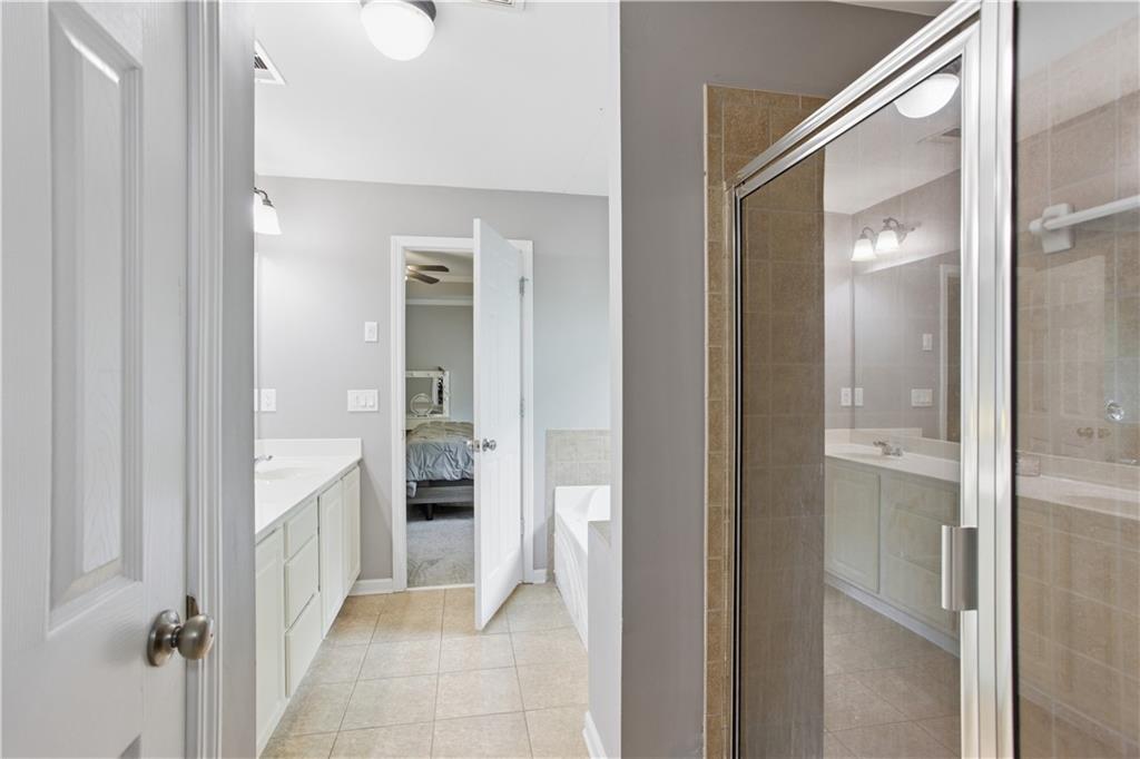 73 Allen Bridge Road Talmo, GA 30575 - Photo 24 of 33 a bathroom with a walk in closet and a mirror