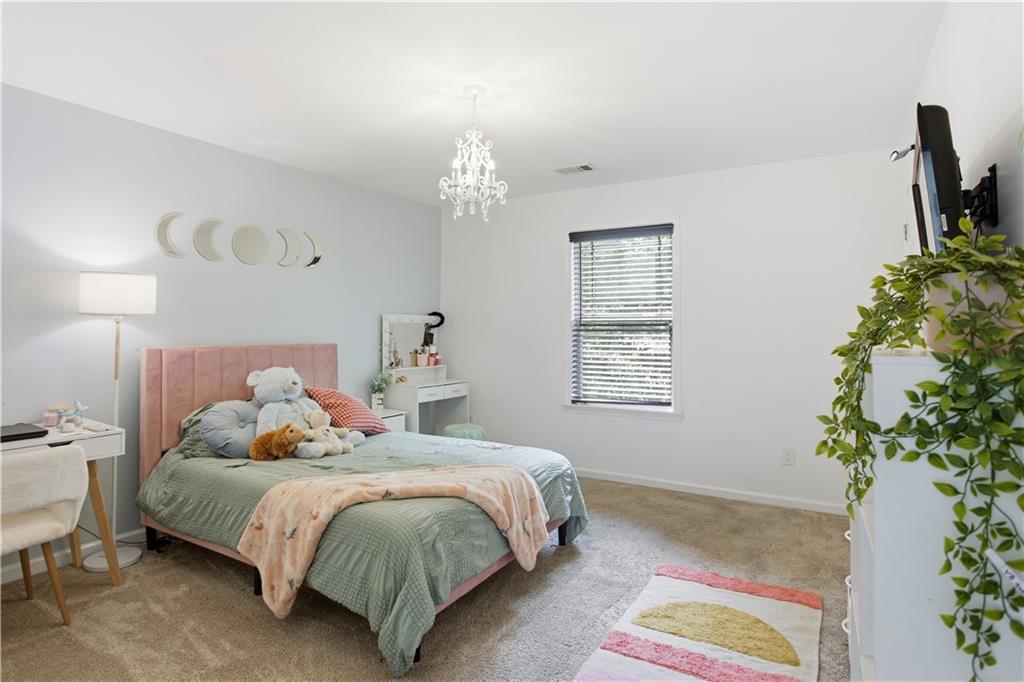 73 Allen Bridge Road Talmo, GA 30575 - Photo 26 of 33 a bedroom with a bed and a potted plant