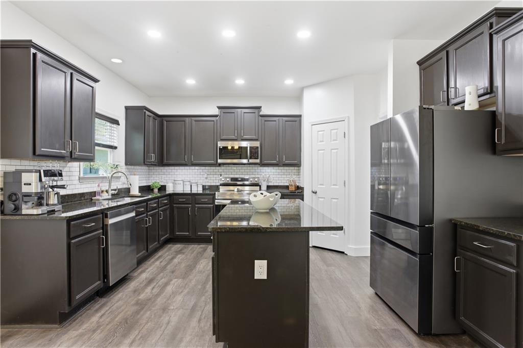73 Allen Bridge Road Talmo, GA 30575 - Photo 10 of 33 a kitchen with stainless steel appliances granite countertop a refrigerator stove top oven and sink
