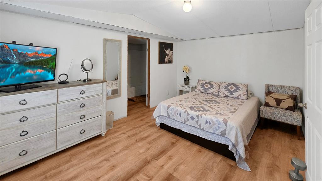 14628 Fm Road Scurry, TX 75158 - Photo 7 of 14 a bedroom with a bed and a flat screen tv