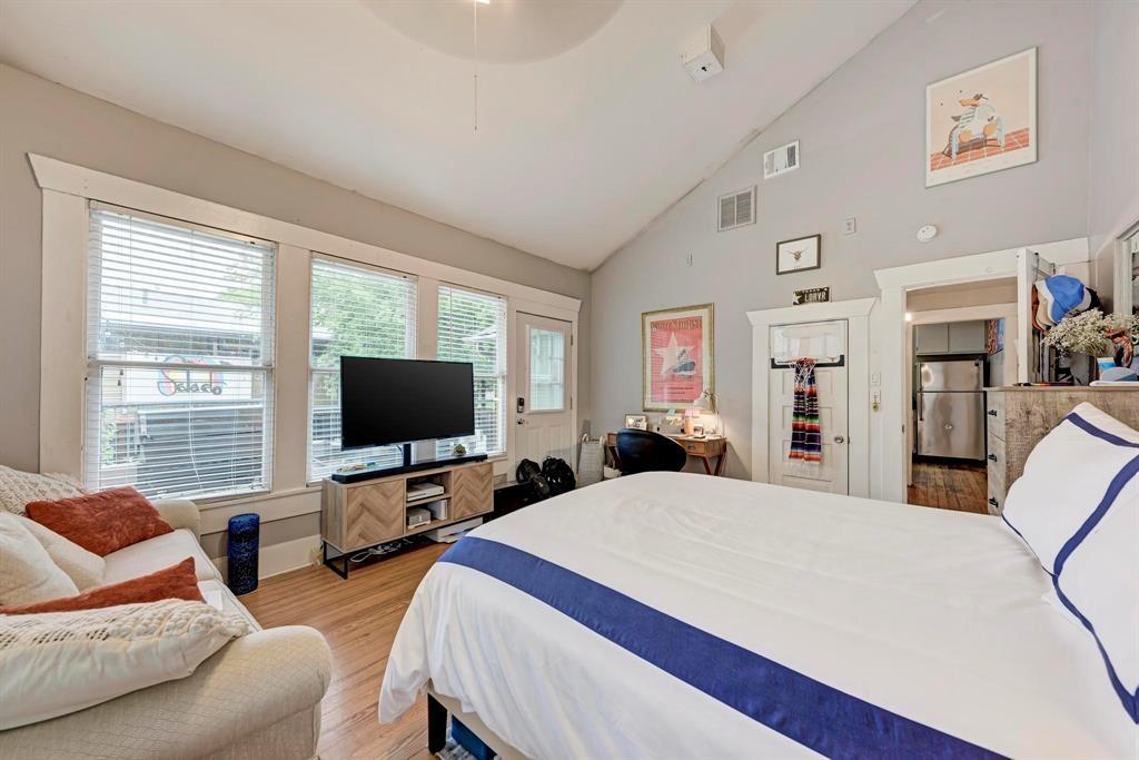 2834 Salado Street Austin, TX 78705 - Photo 14 of 40 a bedroom with a bed and glass windows