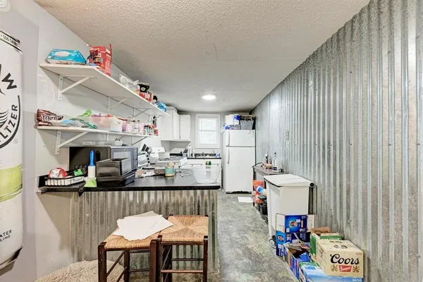 a kitchen with kitchen island a sink a stove and refrigerator