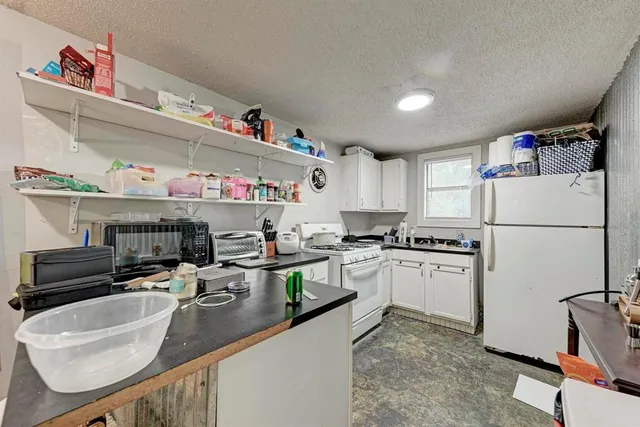 a bathroom with a bathtub shower sink vanity and toilet