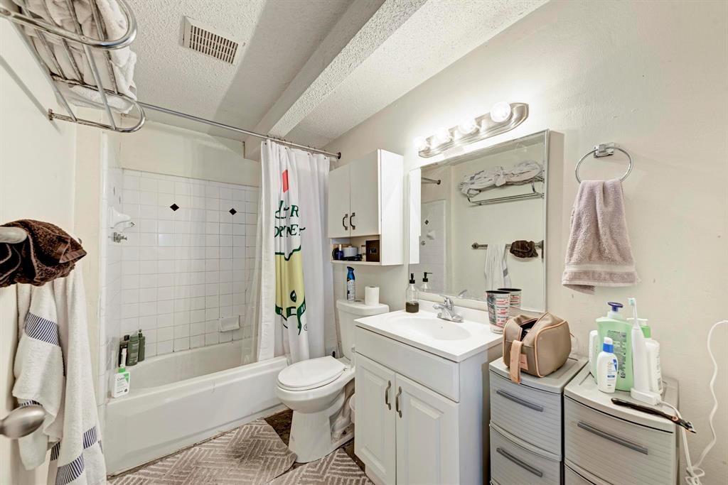 2834 Salado Street Austin, TX 78705 - Photo 27 of 40 a bathroom with a bathtub shower sink vanity and toilet