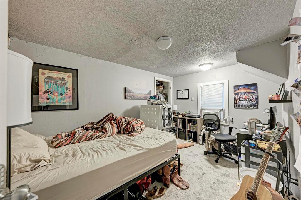 2834 Salado Street Austin, TX 78705 - Photo 28 of 40 a bedroom with furniture and wooden floor