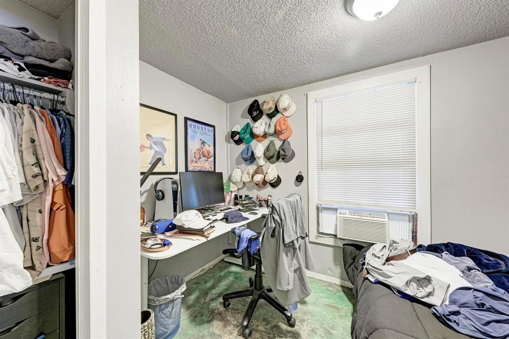 2834 Salado Street Austin, TX 78705 - Photo 30 of 40 a bed sitting in a bedroom next to a window