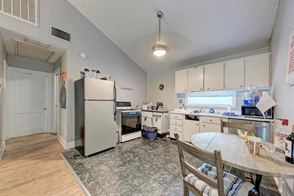 2834 Salado Street Austin, TX 78705 - Photo 32 of 40 a kitchen with refrigerator cabinets and wooden floor