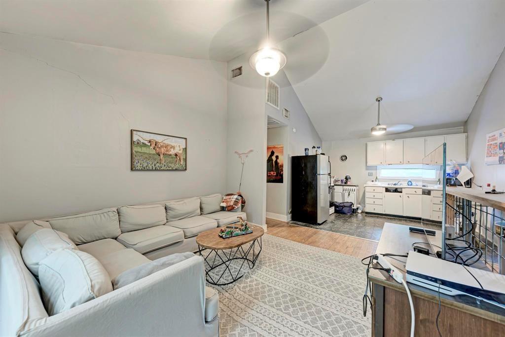 2834 Salado Street Austin, TX 78705 - Photo 35 of 40 a living room with furniture kitchen view and a chandelier