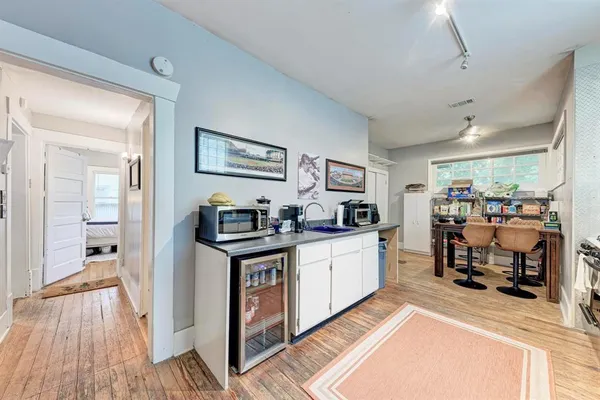 a view of living room with furniture and wooden floor