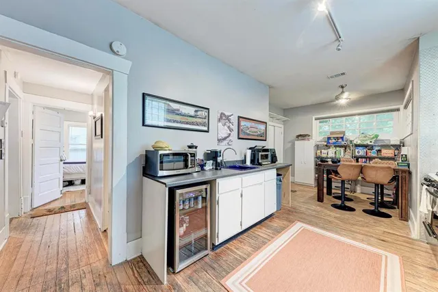a view of living room with furniture and wooden floor