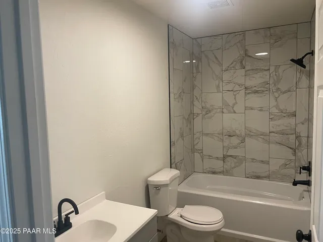 a bathroom with a toilet a sink and a bathtub