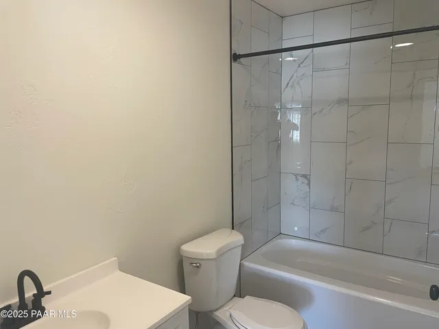 a bathroom with a toilet and a bathtub