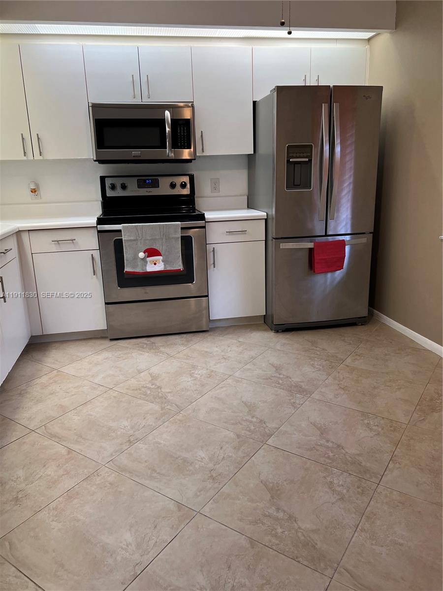 a kitchen with stainless steel appliances a refrigerator and a stove top oven