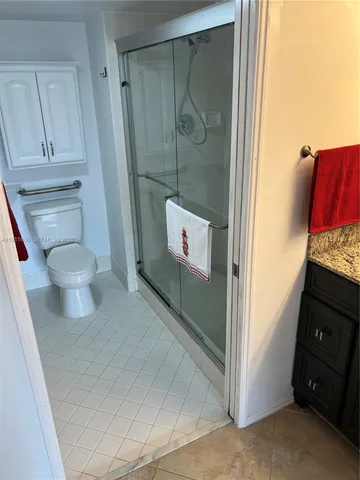 a bathroom with a toilet and a shower
