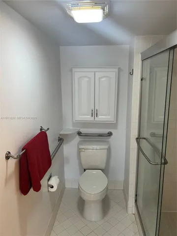 a bathroom with a toilet and a shower