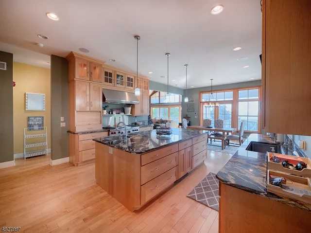 a kitchen with stainless steel appliances granite countertop a stove and a large refrigerator
