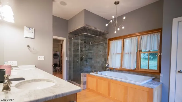 a bathroom with a granite countertop sink and a large mirror