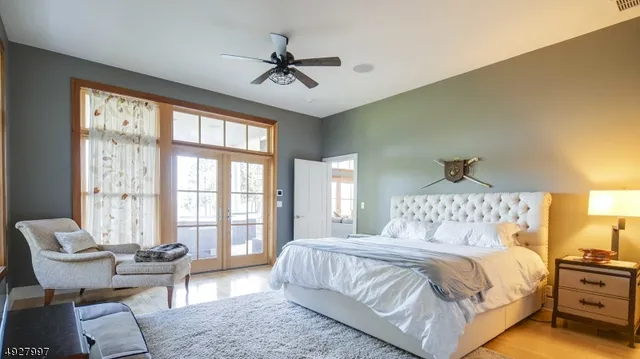 a bedroom with a bed and a chandelier