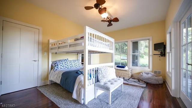 a bedroom with a bed couch and a large window