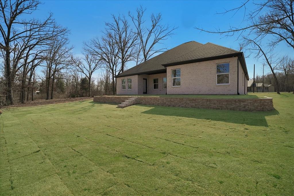 448 Rs County Road Alba, TX 75410 - Photo 30 of 34 a front view of house with yard and trees