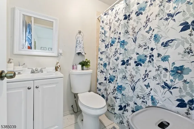 a bathroom with a sink toilet and mirror