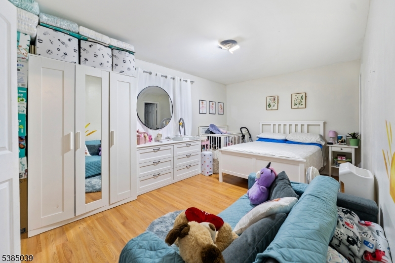 22 Godwin Avenue Paterson, NJ 07501 - Photo 12 of 16 a living room with furniture and a flat screen tv