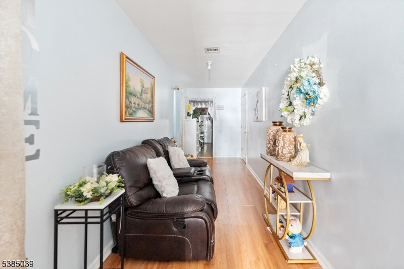 22 Godwin Avenue Paterson, NJ 07501 - Photo 16 of 16 a living room with furniture and a potted plant