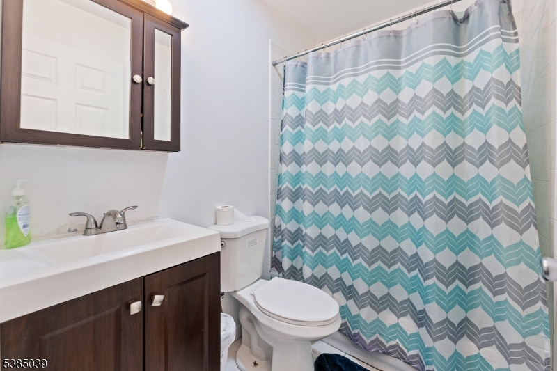 22 Godwin Avenue Paterson, NJ 07501 - Photo 5 of 16 a bathroom with a sink and a toilet