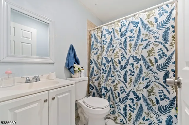 a bathroom with a sink toilet and a mirror